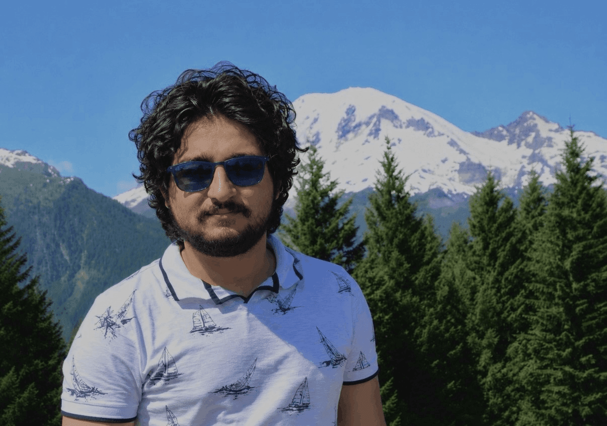 Peter Khorani standing in front of a mountain landscape